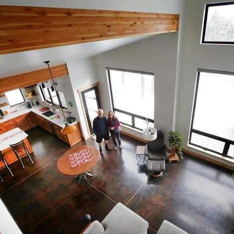 Light Filled Room with Passive Solar Design, Concrete Floors, and Exposed Beams.